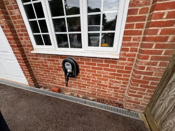 EV charger installation on a brick wall
